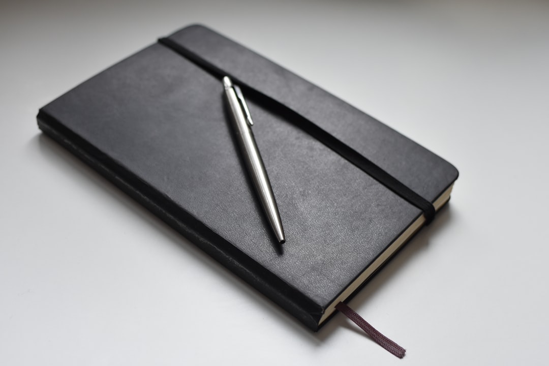 silver click pen on black book silver click pen on black book